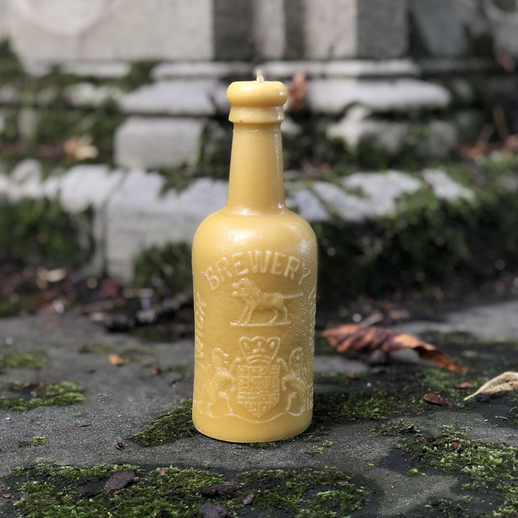 This striking beeswax candle is created from an original Alnwick Brewery antique bottle. With approximately 70 hours of burn time, watch as the candle's flame slowly begins to light up the intricate lion crest. Hand poured in the UK using 100% British beeswax.