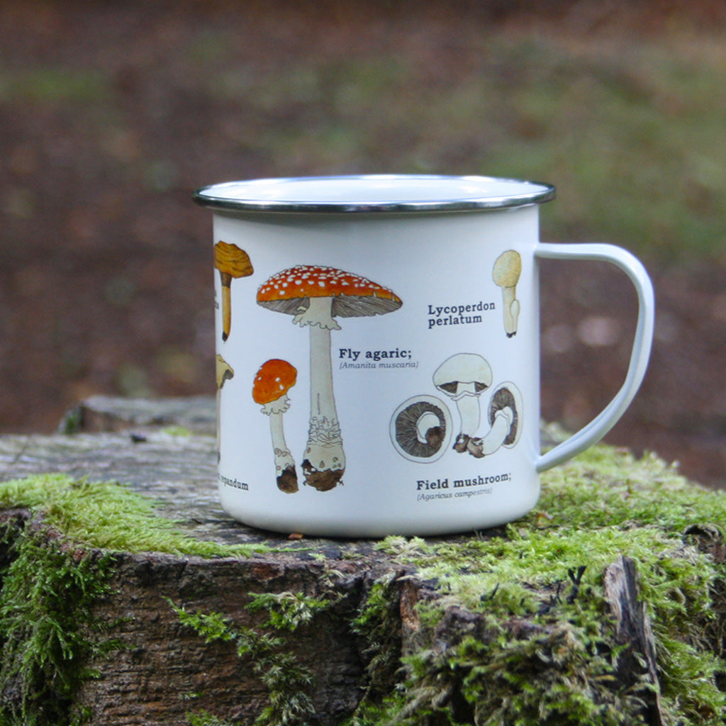 We are in love with our ecology enamelware mugs! Mushrooms of all shapes and sizes adorn this classically illustrated enamel mug. Any forager's best friend! These mugs are a perfect eco-friendly alternative to disposable cups. Available in a range of styles! Bring the magic of the outdoors in, or embrace nature or take it with you!