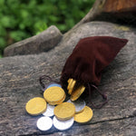 Load image into Gallery viewer, A pouch of loot fit for an adventure!   150g of white chocolate (silver) and milk chocolate (gold) coins fill this velvet drawstring bag - perfect for the swashbuckler or heroic outlaw in your life! Who doesn&#39;t love chocolate coins? Now you can take them with you - just make sure you leave enough to pay any tolls or taverns along your way! 
