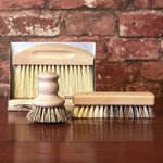 Load image into Gallery viewer, Help save the planet while doing the dishes! Our eco-friendly wooden pot brush is the handy solution to scrub your pots, pans and plates! Ideally shaped to fit in your hand, this sweet little brush will look cute on your counter top and is made from certified beech wood with vegan plant-based bristles.
